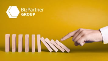 A man hand with domino effect - BizPartner Group