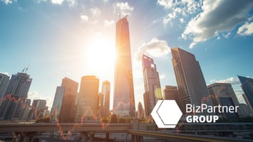 A city with bright sun shining through tall skyscraper - BizPartner EN Group