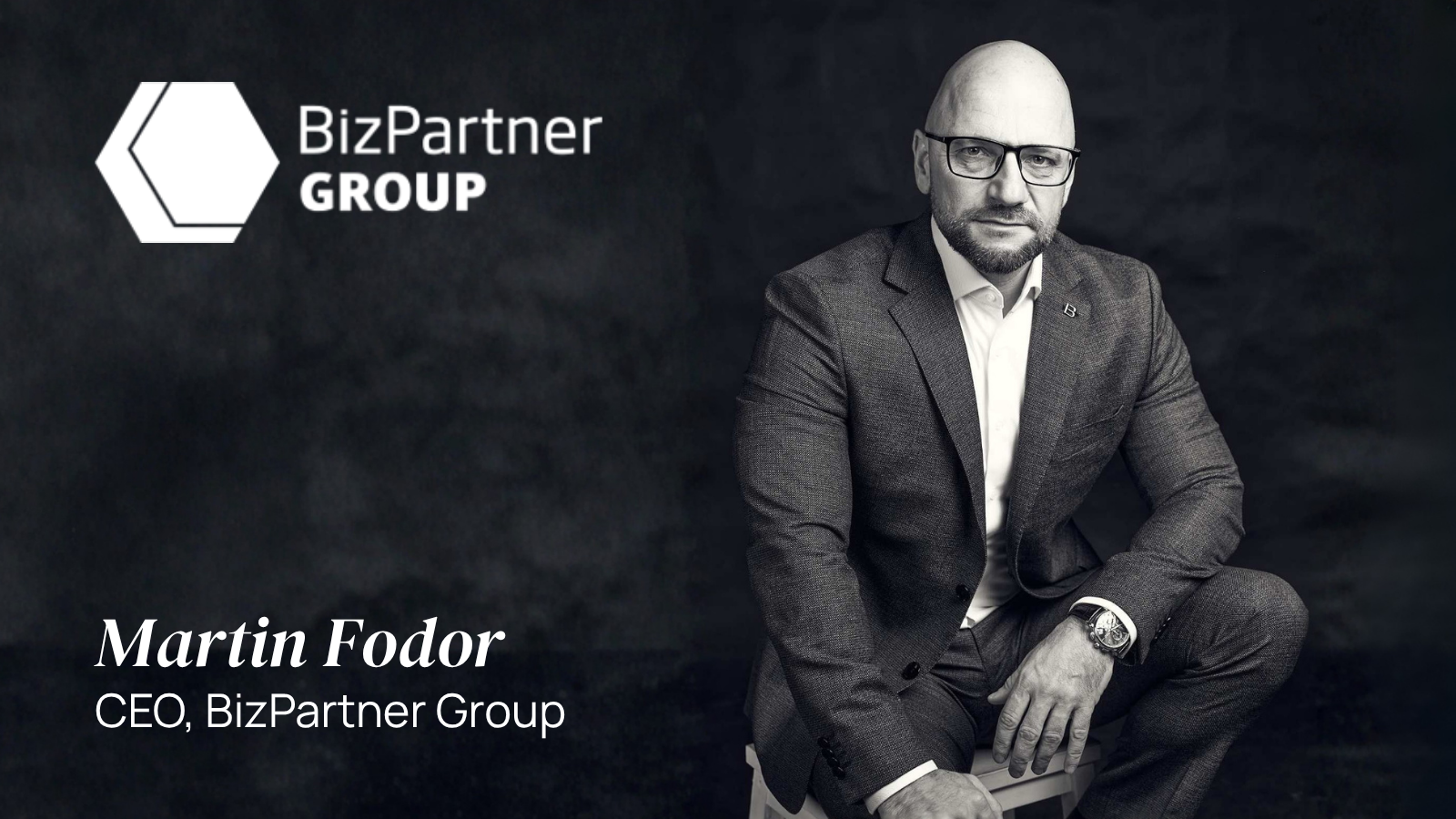 Martin Fodor, CEO Sitting on a wooden chair with dark mesh background blog image