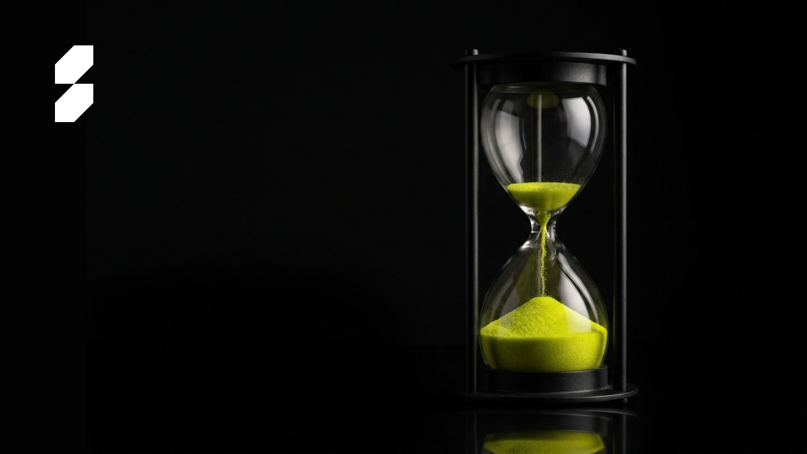 Time is ticking with green sand on dark colored background